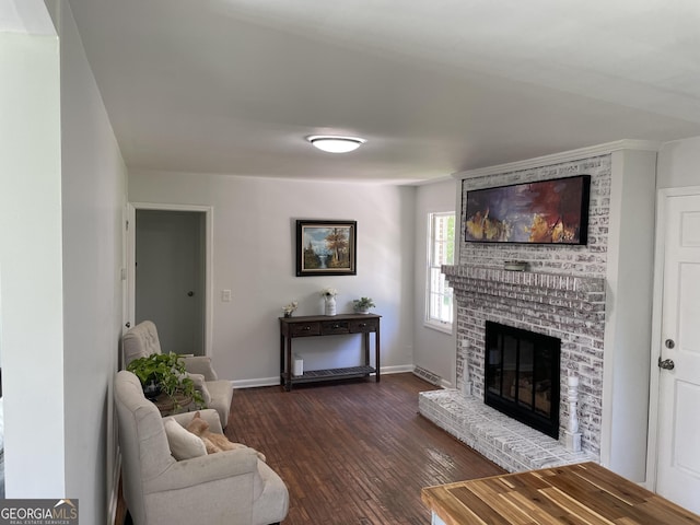 1202 Franklin Rd SW, Plainville, GA 30733 - living area featuring a brick fireplace, dark wood-type flooring, and baseboards
