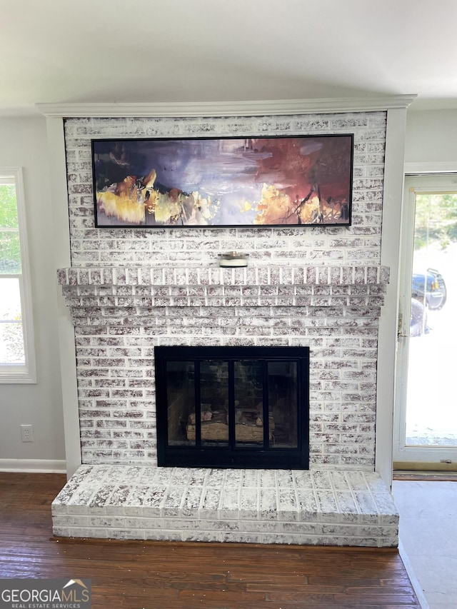 1202 Franklin Rd SW, Plainville, GA 30733 - detailed view of a fireplace, wood finished floors, and baseboards