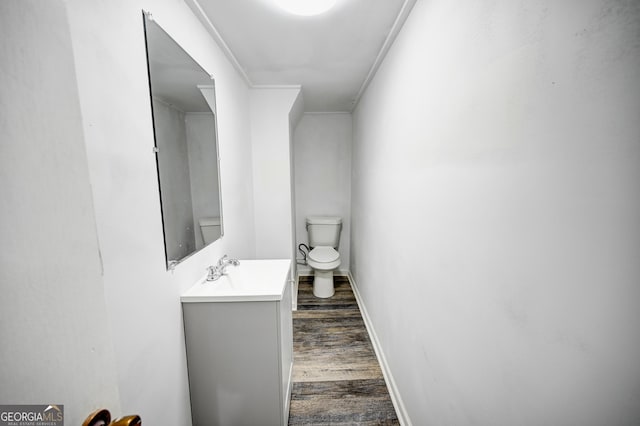 1202 Franklin Rd SW, Plainville, GA 30733 - half bathroom featuring wood finished floors, toilet, vanity, and baseboards