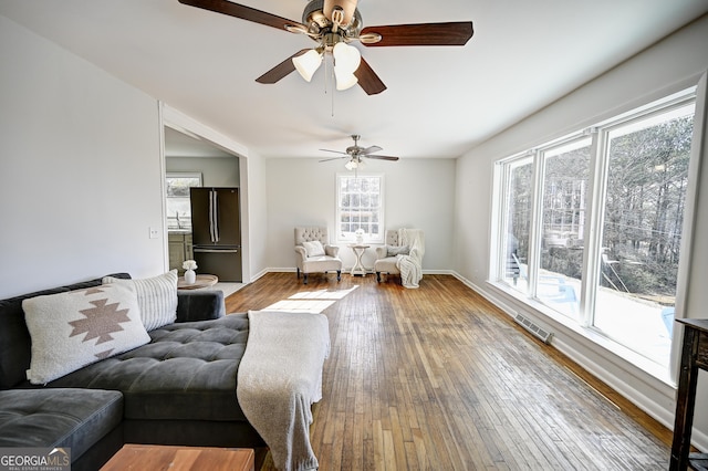 1202 Franklin Rd SW, Plainville, GA 30733 - living room with a ceiling fan, hardwood / wood-style floors, and baseboards