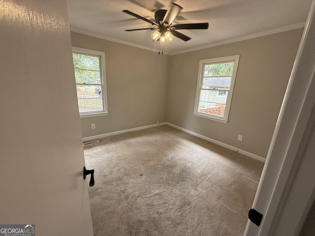 unfurnished room featuring light carpet, ornamental molding, and ceiling fan