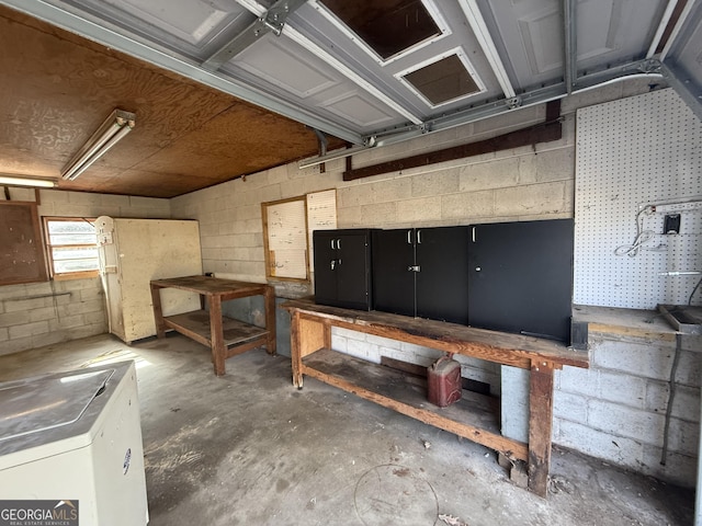 basement featuring washer / dryer and a workshop area