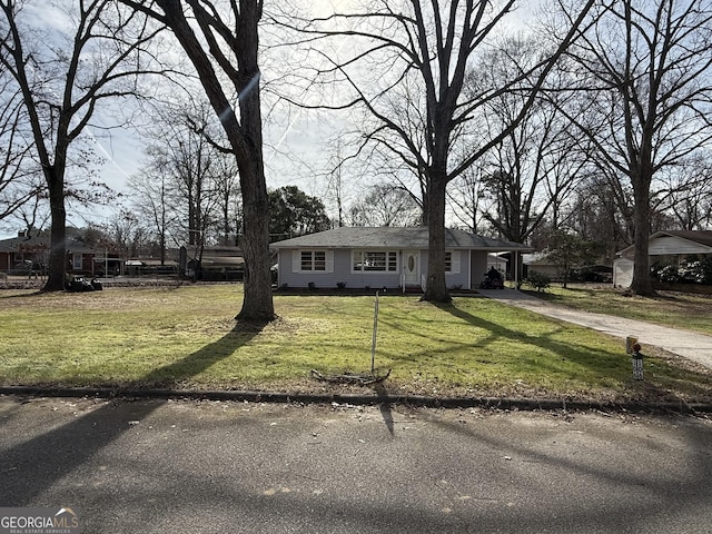 view of front facade with a front yard and a carport