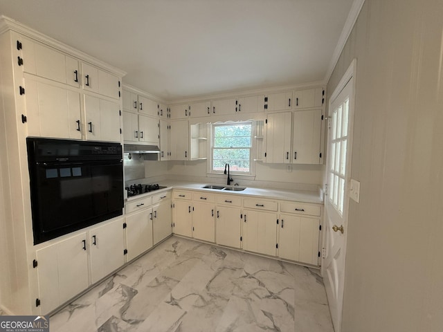 kitchen featuring crown molding, white cabinetry, sink, and black appliances