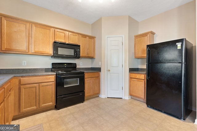 kitchen featuring a textured ceiling and black appliances