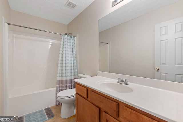 full bathroom featuring vanity, a textured ceiling, shower / bath combination with curtain, and toilet