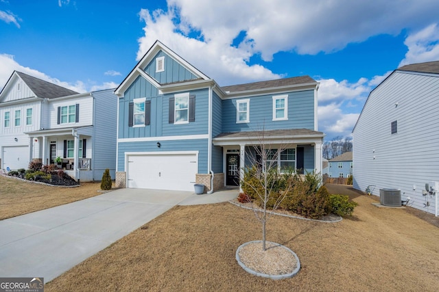 view of front of house featuring a front yard, a garage, central AC, and covered porch