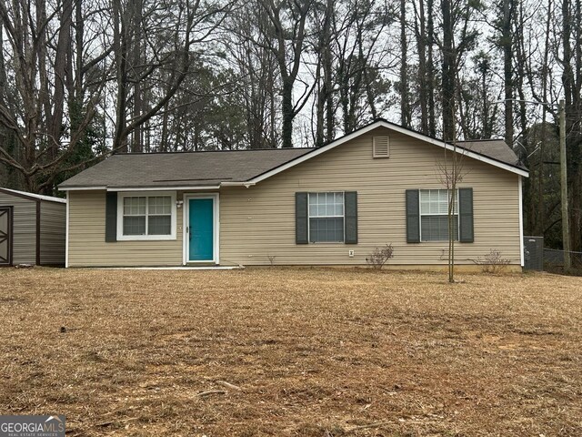 single story home featuring a storage unit