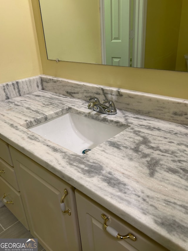 bathroom featuring tile patterned flooring and vanity