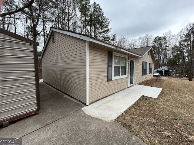 view of property exterior with a patio area