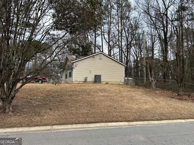 view of side of property with central AC unit