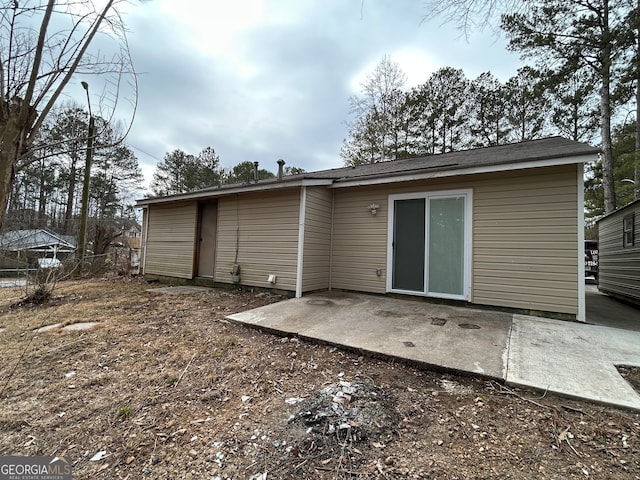 back of property with a patio