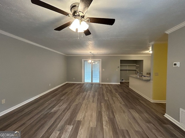 unfurnished living room with sink, ornamental molding, dark hardwood / wood-style floors, and a textured ceiling