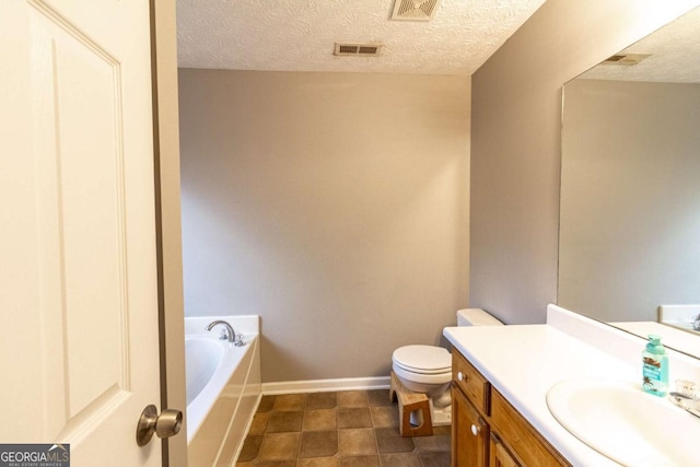 bathroom with baseboards, visible vents, toilet, a garden tub, and vanity