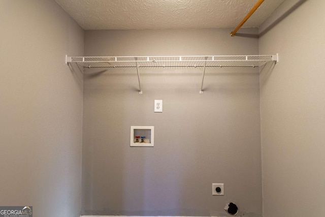 clothes washing area with washer hookup, laundry area, hookup for an electric dryer, and a textured ceiling