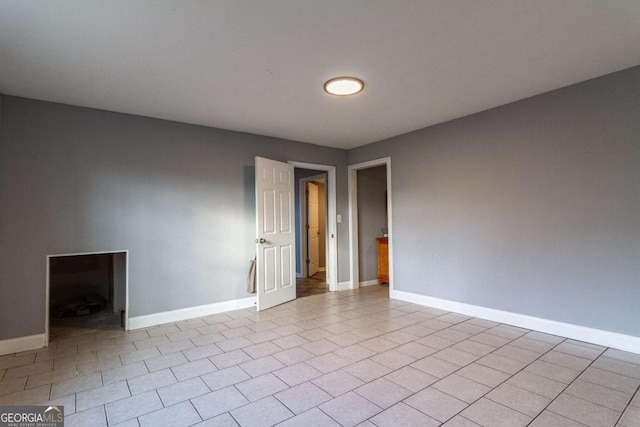 tiled empty room with baseboards