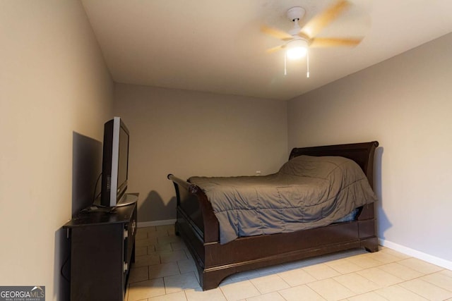 bedroom with ceiling fan, baseboards, and light tile patterned floors