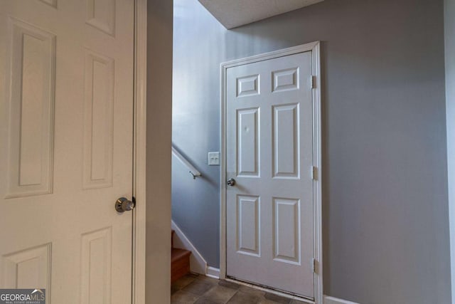 interior space with stairs and baseboards