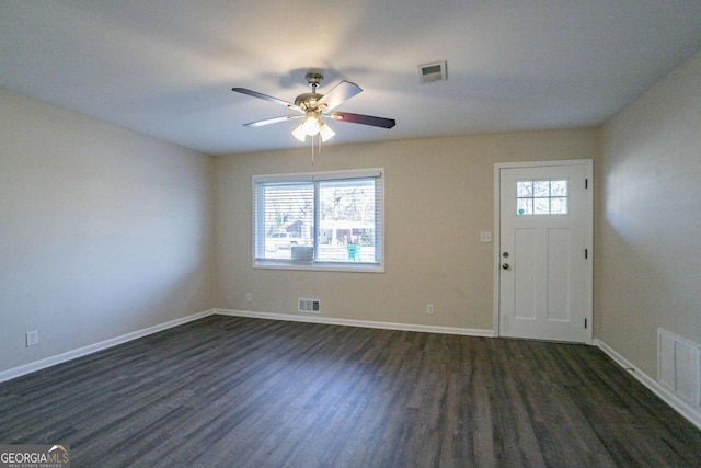 entrance foyer with ceiling fan, a wealth of natural light, and dark hardwood / wood-style flooring