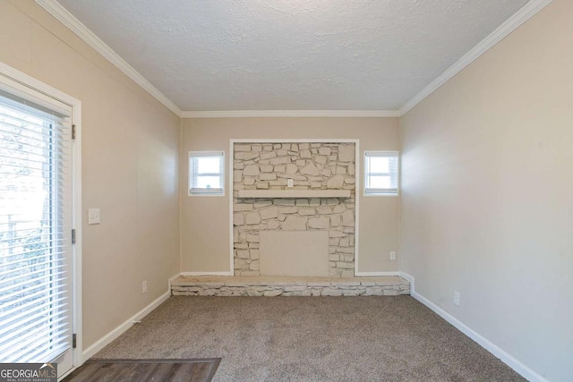 unfurnished living room with ornamental molding, carpet floors, a fireplace, and a textured ceiling