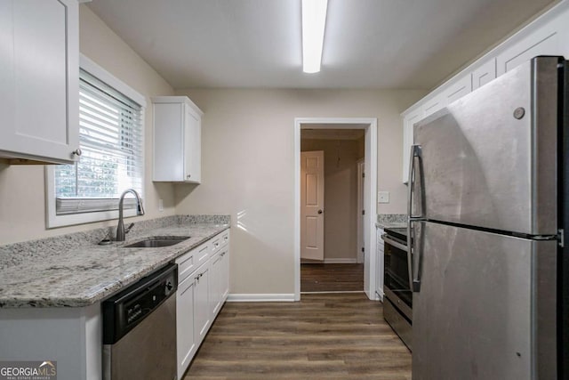 kitchen featuring light stone countertops, appliances with stainless steel finishes, sink, and white cabinets