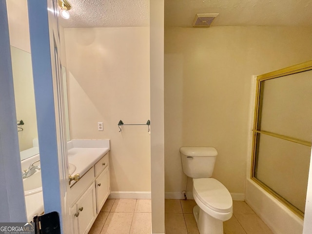 full bathroom with enclosed tub / shower combo, vanity, a textured ceiling, tile patterned floors, and toilet