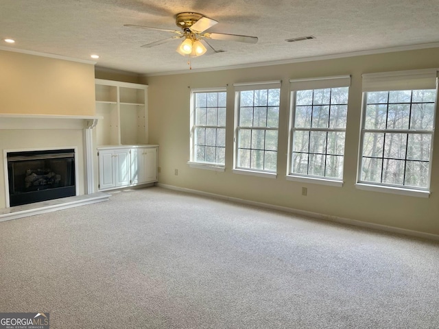 unfurnished living room with ornamental molding and a textured ceiling