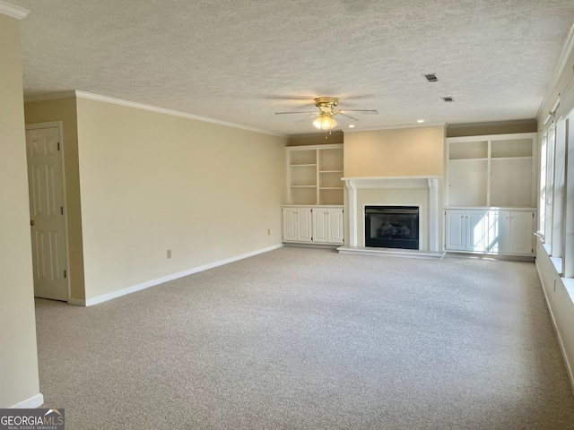 unfurnished living room featuring ornamental molding, light carpet, a textured ceiling, and ceiling fan