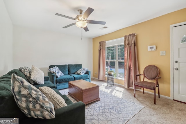 living room with ceiling fan and light colored carpet