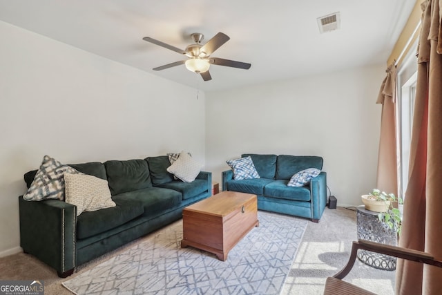 living room with light colored carpet and ceiling fan