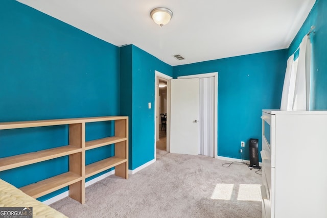 unfurnished bedroom featuring light colored carpet