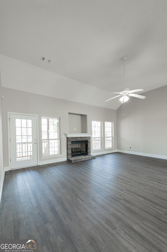 unfurnished living room with ceiling fan, lofted ceiling, and a fireplace