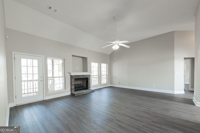 unfurnished living room with ceiling fan, plenty of natural light, a fireplace, and dark hardwood / wood-style flooring