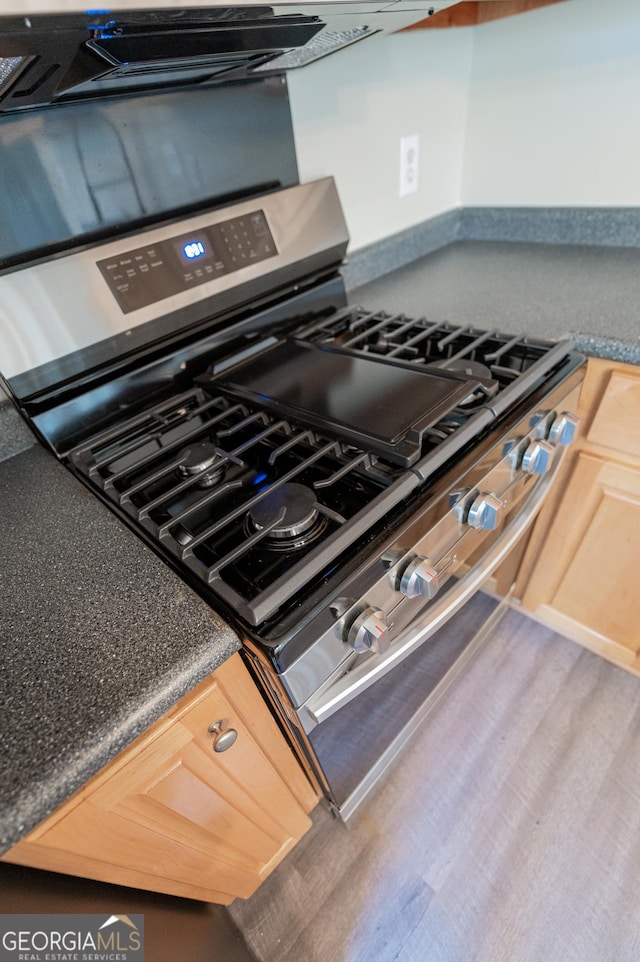 details featuring stainless steel range with gas cooktop and light brown cabinets