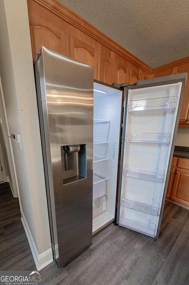 kitchen featuring dark wood-type flooring, a textured ceiling, and stainless steel refrigerator with ice dispenser