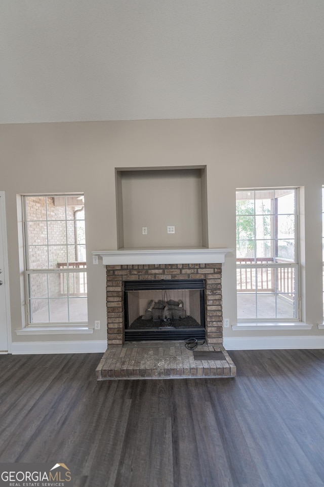 details featuring hardwood / wood-style flooring and a brick fireplace