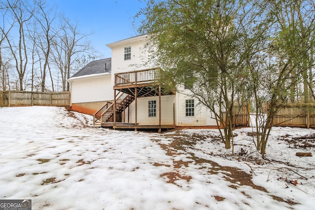 snow covered property featuring a wooden deck