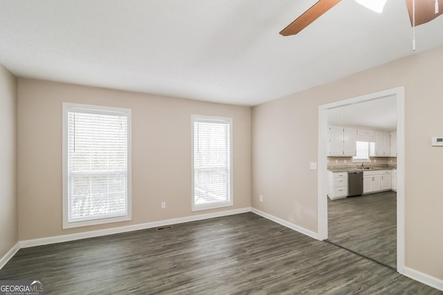 spare room with sink, dark hardwood / wood-style floors, and ceiling fan