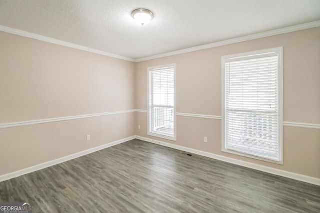 spare room with ornamental molding, dark hardwood / wood-style floors, and a textured ceiling