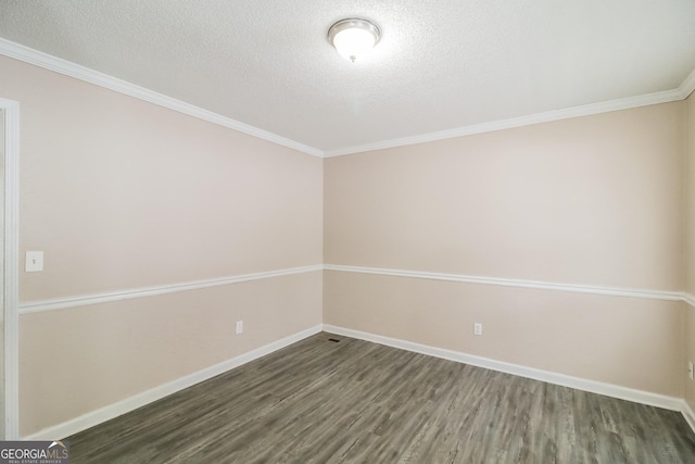 unfurnished room featuring dark wood-type flooring, ornamental molding, and a textured ceiling