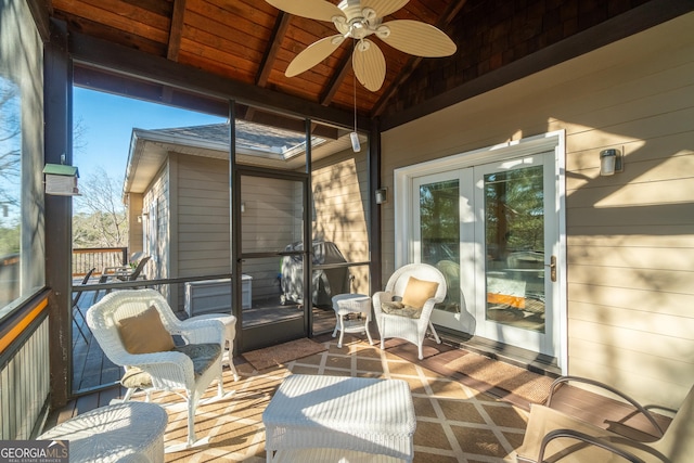 sunroom / solarium featuring wood ceiling, vaulted ceiling, and ceiling fan