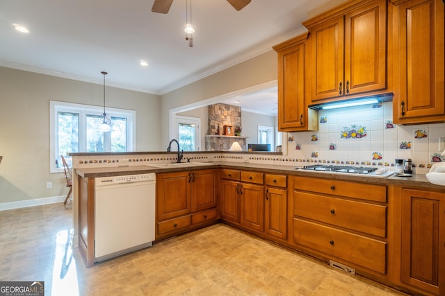 kitchen featuring sink, decorative backsplash, gas cooktop, white dishwasher, and kitchen peninsula