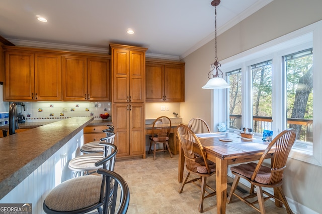 kitchen featuring ornamental molding, pendant lighting, and decorative backsplash