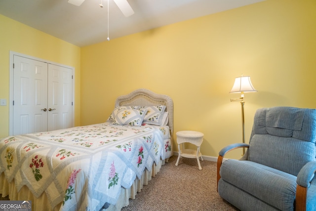 carpeted bedroom with ceiling fan and a closet