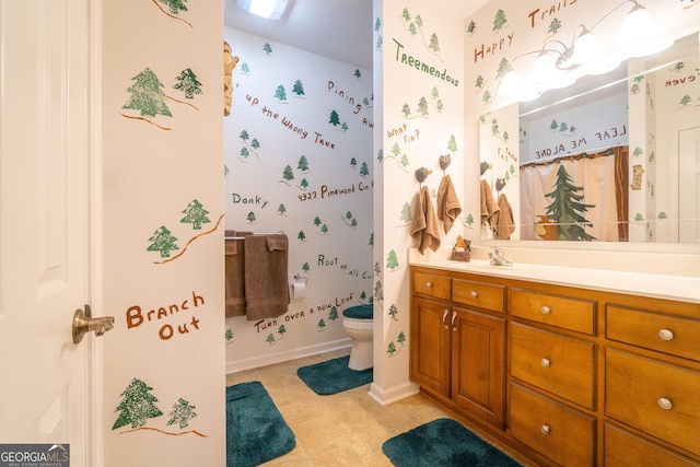 bathroom featuring tile patterned floors, toilet, and vanity