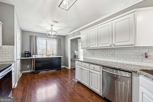 kitchen with light stone countertops, white cabinetry, appliances with stainless steel finishes, and dark wood-type flooring