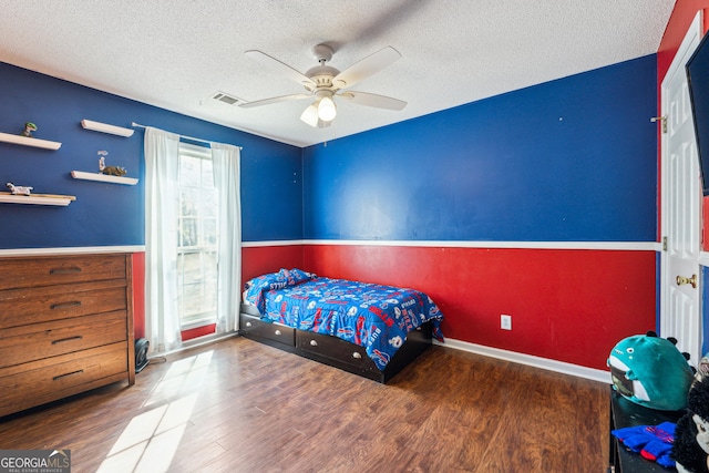 bedroom with hardwood / wood-style floors, a textured ceiling, and ceiling fan