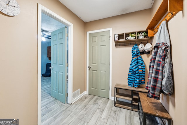 mudroom with light hardwood / wood-style floors