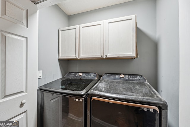 laundry area with cabinets and separate washer and dryer