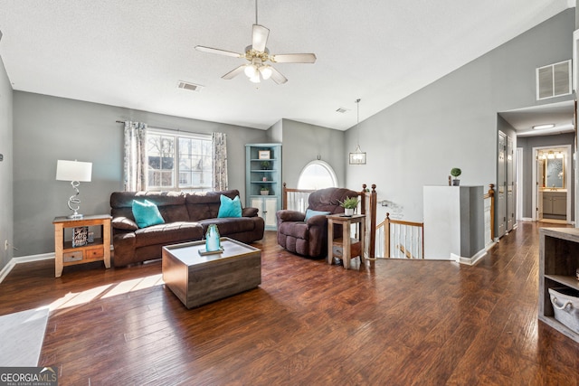 living room with a textured ceiling, dark wood-type flooring, high vaulted ceiling, and ceiling fan